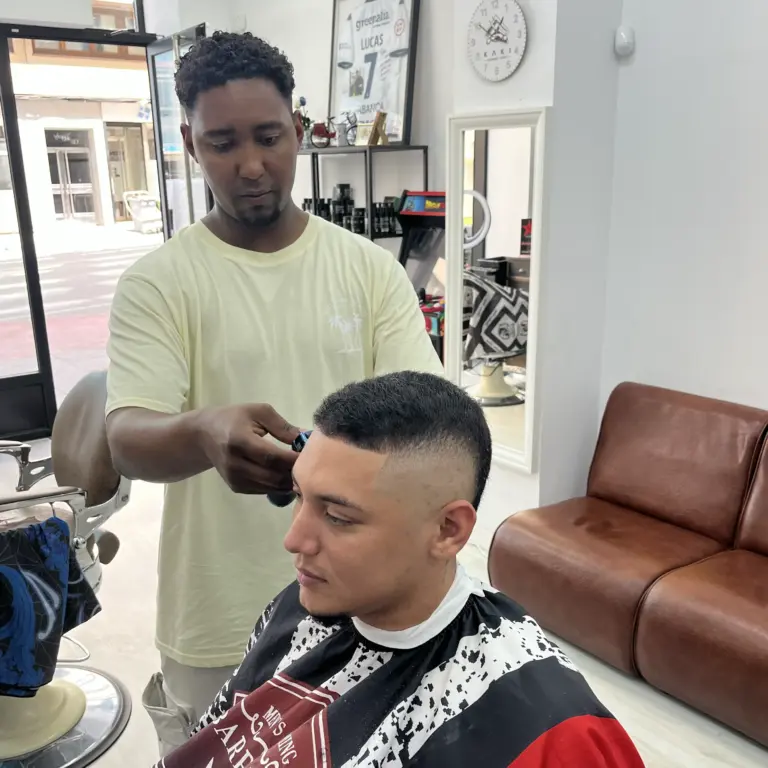 Cliente recibiendo un corte low fade con degradado suave en A Coruña